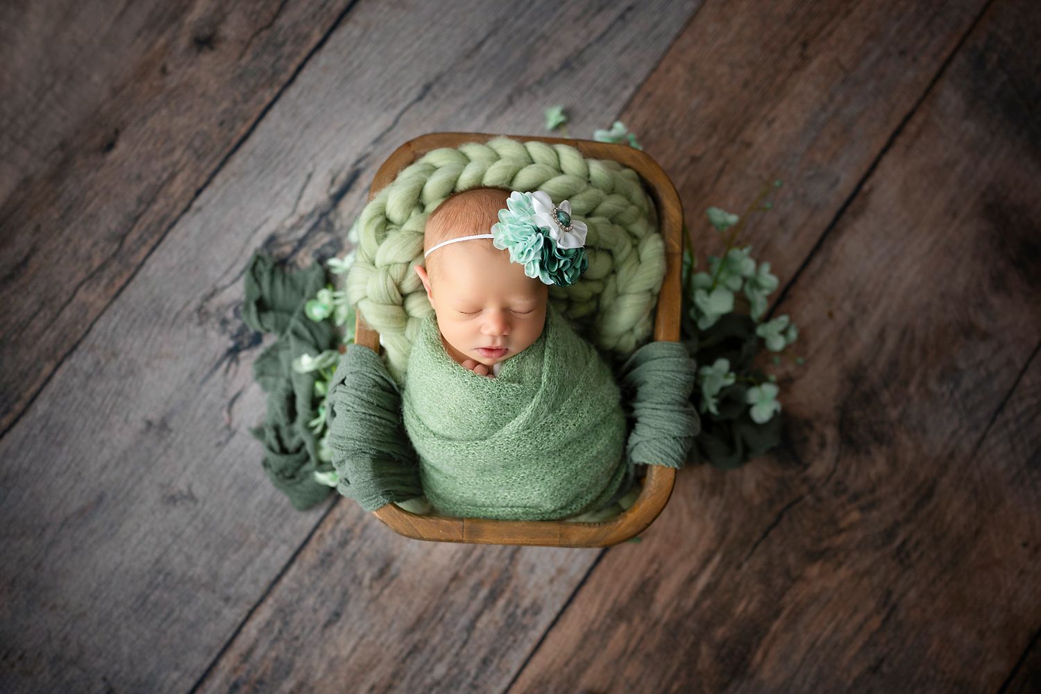 Newborn baby asleep in a studio prop